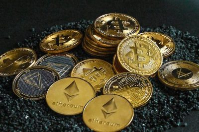image showing bitcoin and ethereum crypto currency in a messy pile on black background